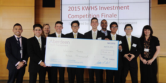 The six students from West Ranch High School's Western Trade team (yellow ties) took home first-prize winnings of $3,000. They are pictured here with three Aberdeen Asset Management judges and their teacher, Linda Cox (right).