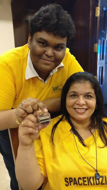 Rirath Shaarook with his mentor, Srimathy Kesan, showing off their lightweight satellite creation.