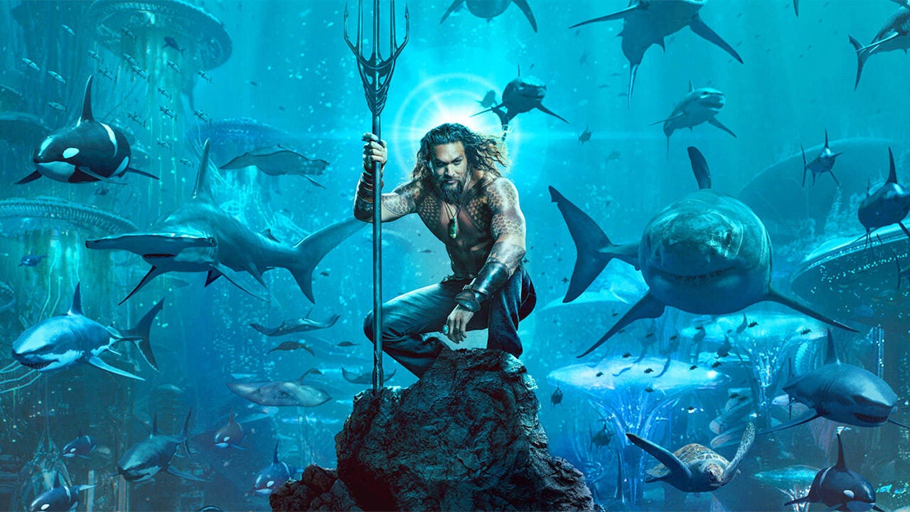 An underwater scene with a person holding a trident, surrounded by sharks and orcas in a city-like ocean setting.