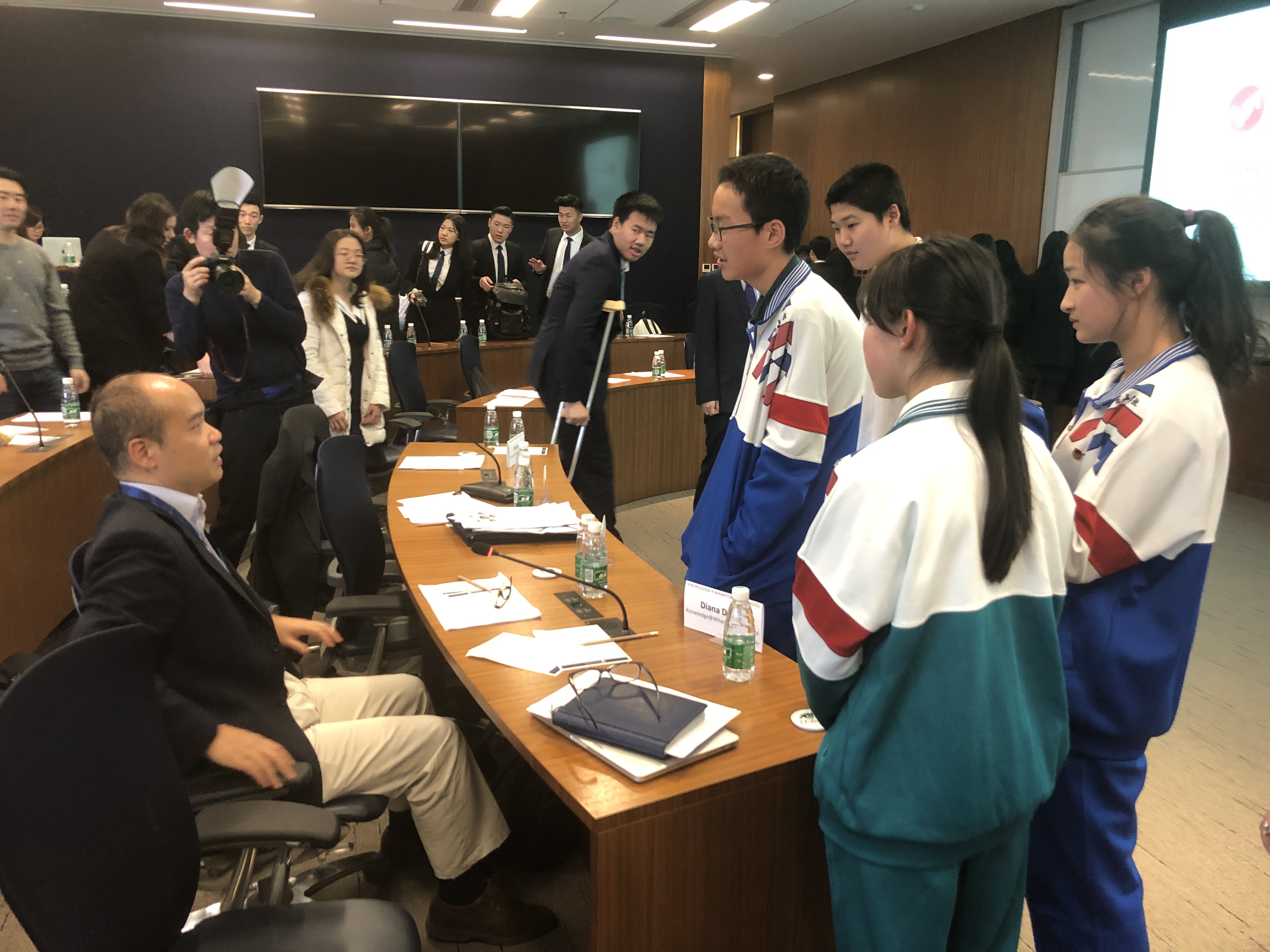 Members of Team Coconut Union Jingshan talk with judge, Yanbing Qiu.