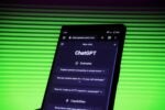 A smartphone screen displaying the ChatGPT website, showcasing examples of prompts, set against a background with green horizontal lines.