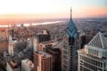 overhead view of the Chrysler Building and the Philadelphia skyline, including the Delaware River in the distance.