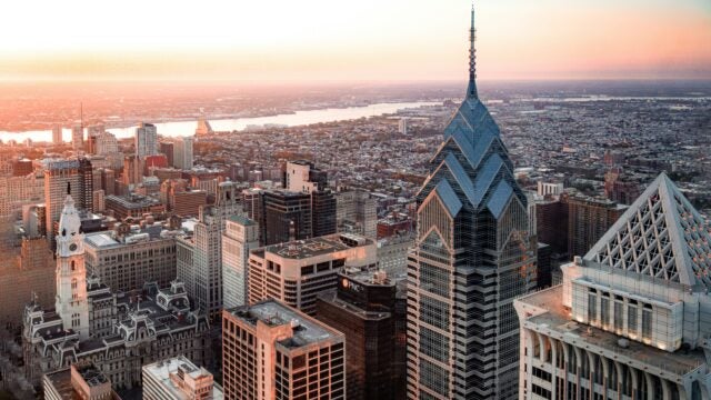 overhead view of the Chrysler Building and the Philadelphia skyline, including the Delaware River in the distance.