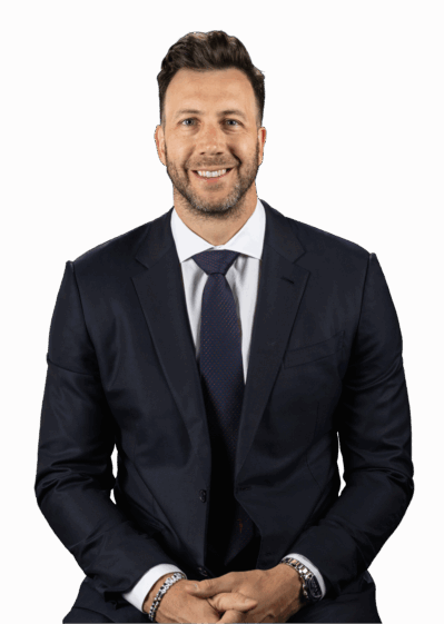 Headshot of a person in a dark suit and tie, with a neutral background, smiling and seated.